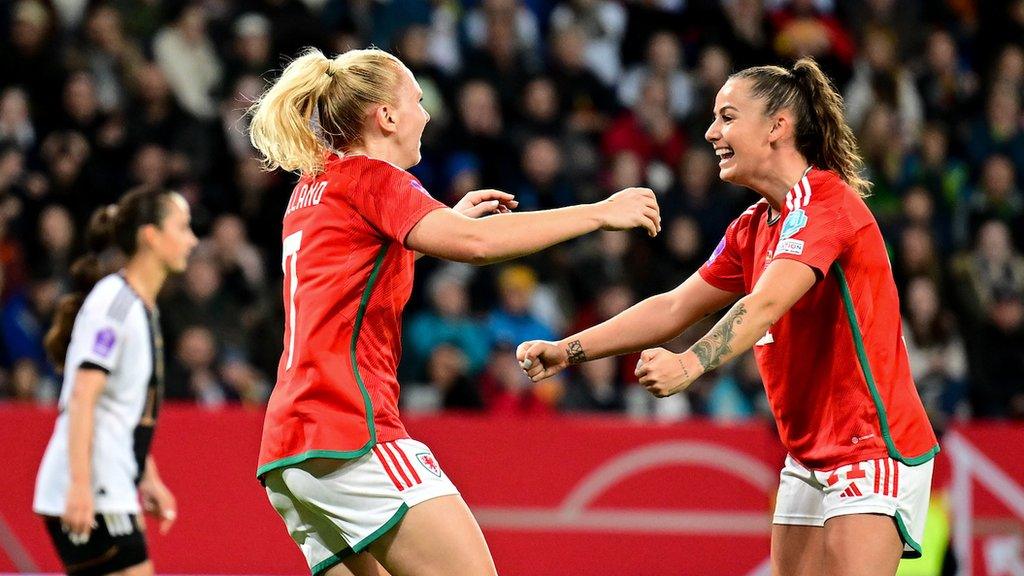 Ceri Holland celebrates scoring Wales' goal with team-mate Hannah Cain against Germany