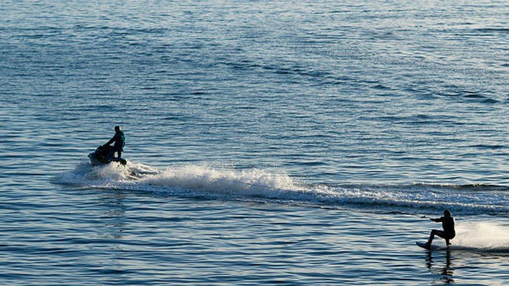 Jet ski and waterskier