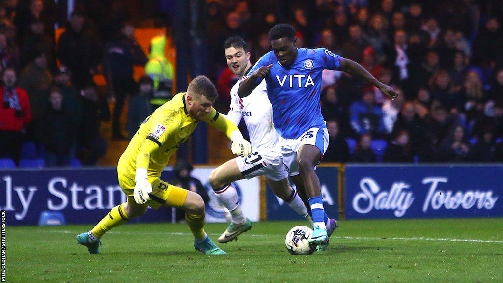 Stockport's Isaac Olaofe rounds the keeper on the way to scoring their third goal