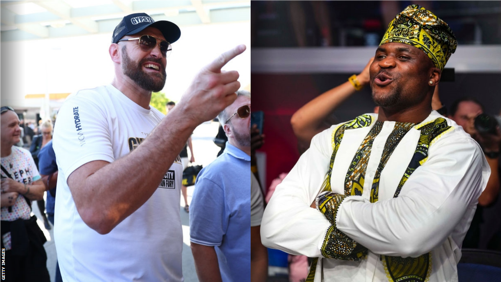 Tyson Fury pointing and smiling beside a picture of Francis Ngannou smiling