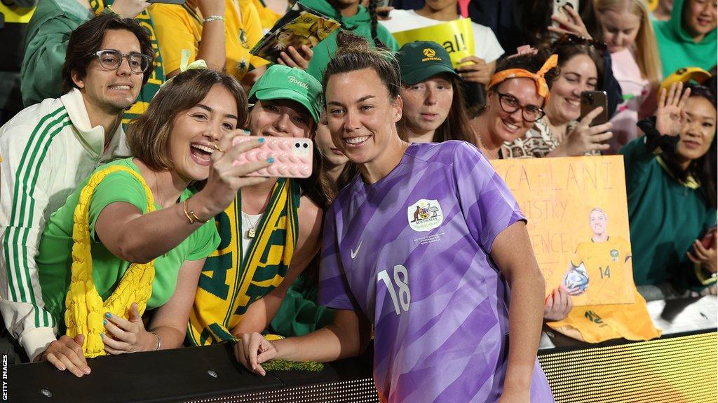 Mackenzie Arnold posing for photos with Australia fans