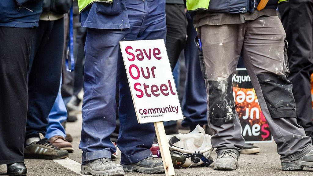 Steel workers with union placard