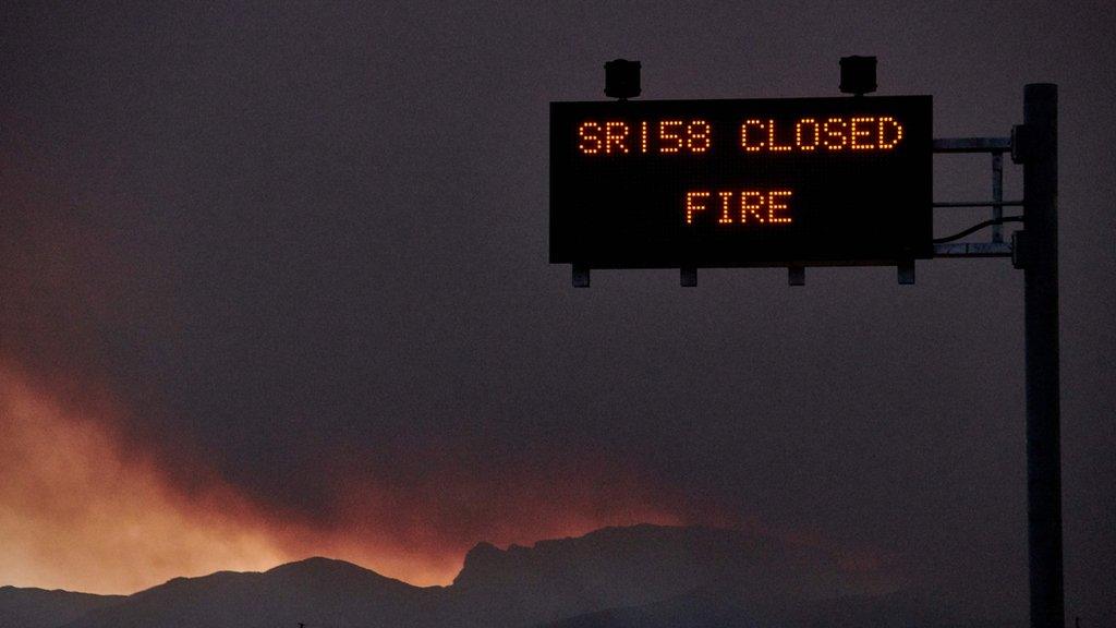 Road sign warns drivers of road closures due to the fire