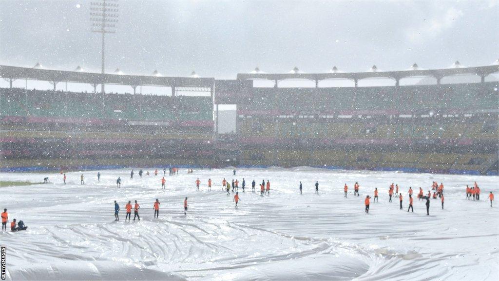 The Barsapara Cricket Ground in Guwahati covered in sheets because of rain