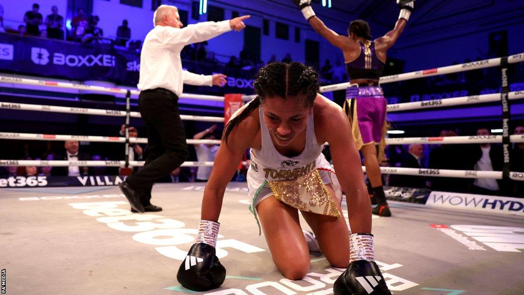 Magali Rodriguez on her knees with Caroline Dubois celebrating in the background