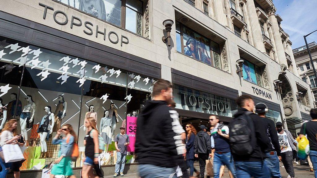 People walk past Topshop, Oxford Street