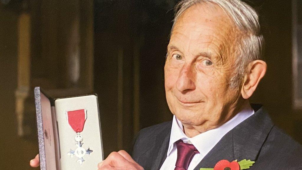 man receiving MBE