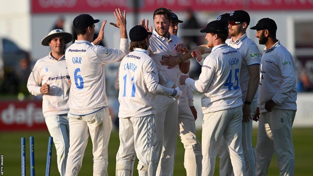 England and Sussex seamer Ollie Robinson celebrates a wicket with team-mates