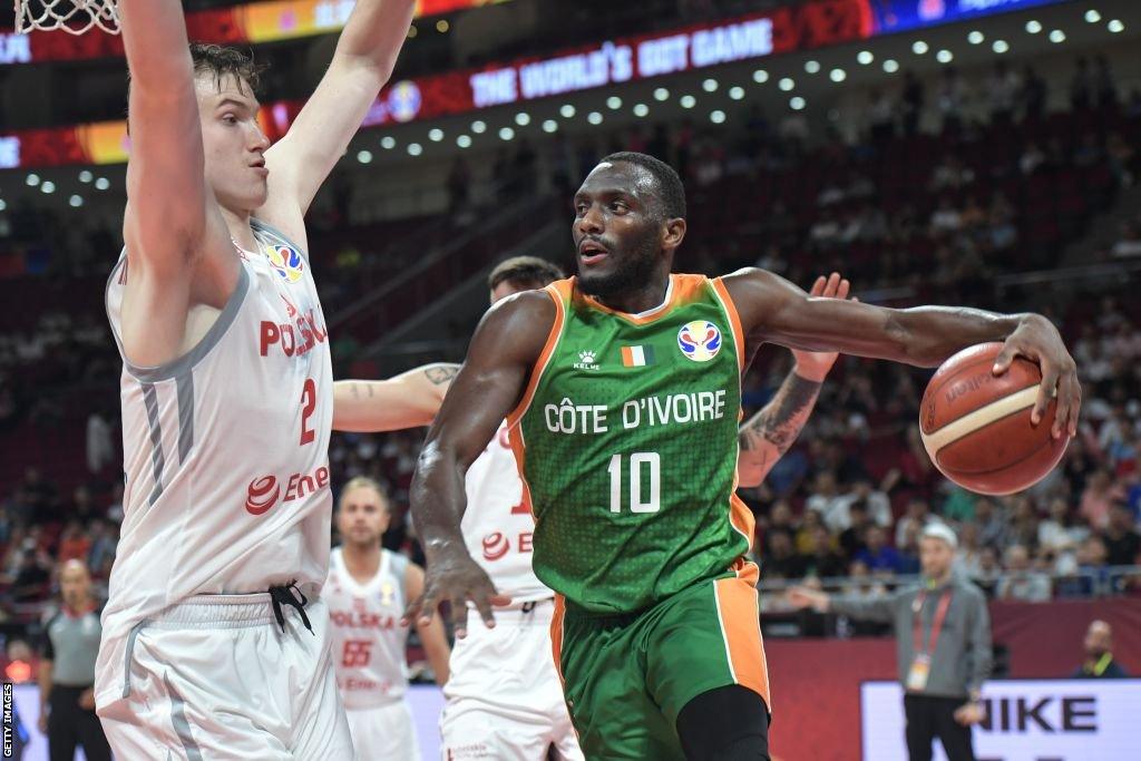 Souleyman Diabate drives the ball against Aleksander Roman Balcerowski of Poland