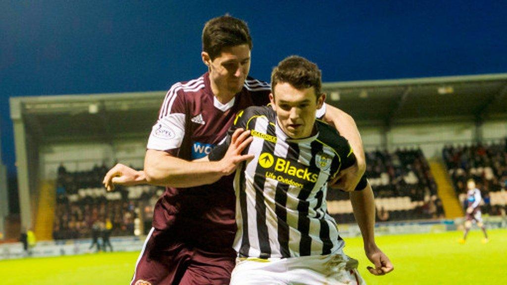 Dylan McGowan of Hearts tussles with St Mirren's John McGinn