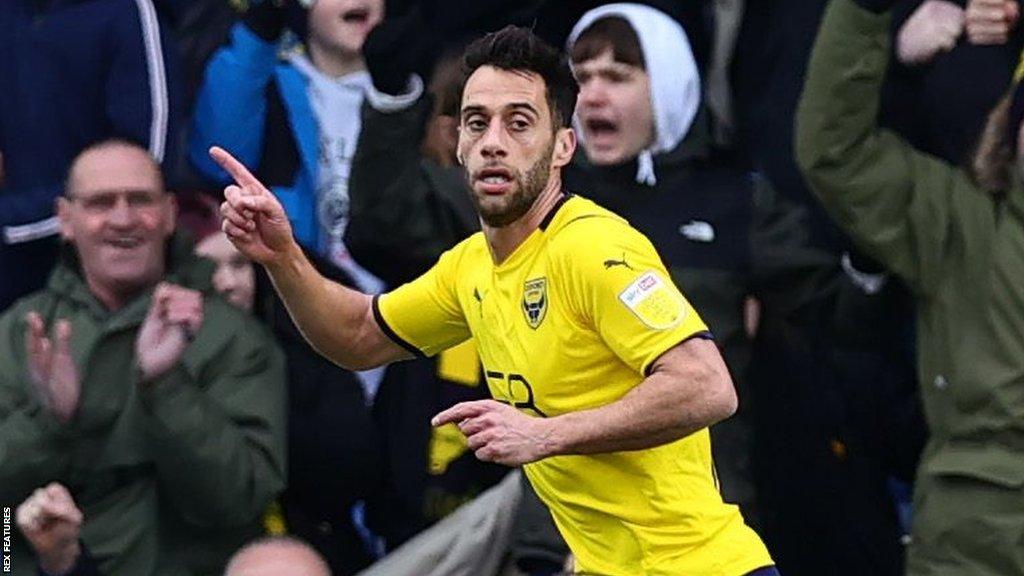 Sam Baldock celebrates scoring a goal for Oxford in March 2022