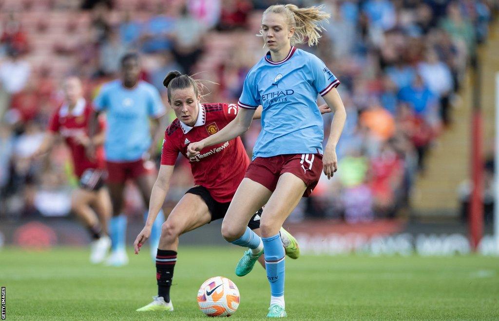 Esme Morgan taking on Ella Toone in the Manchester derby