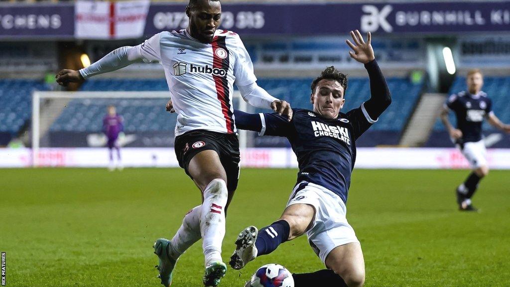 Millwall defender Jake Cooper challenges Antoine Semenyo for the ball