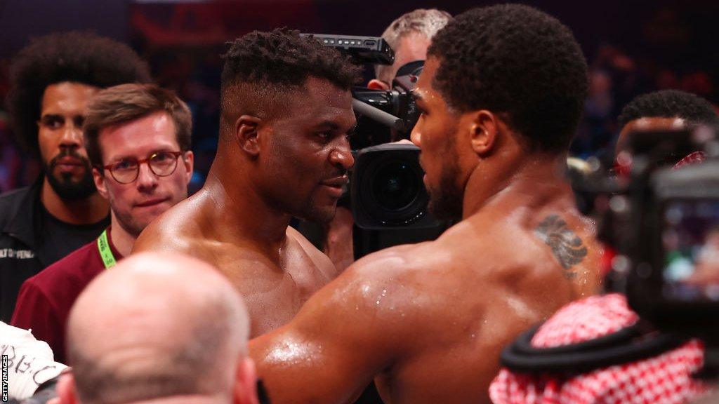 Francis Ngannou is consoled by Anthony Joshua