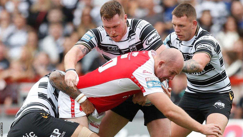 Hull KR prop George King muscles up against Scott Taylor, Jordan Lane of Hull FC