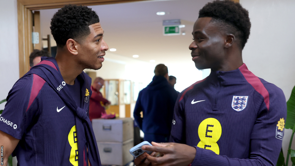 Bukayo Saka (right) talks to England team-mate Jude Bellingham