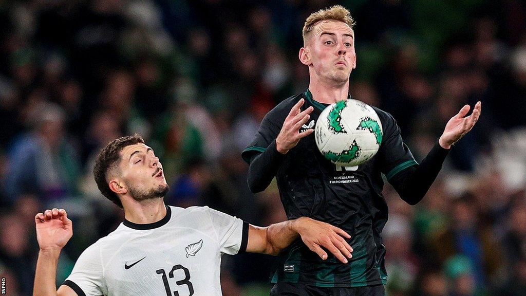 New Zealand's Liberato Cacace challenges Mark Sykes during the Dublin friendly