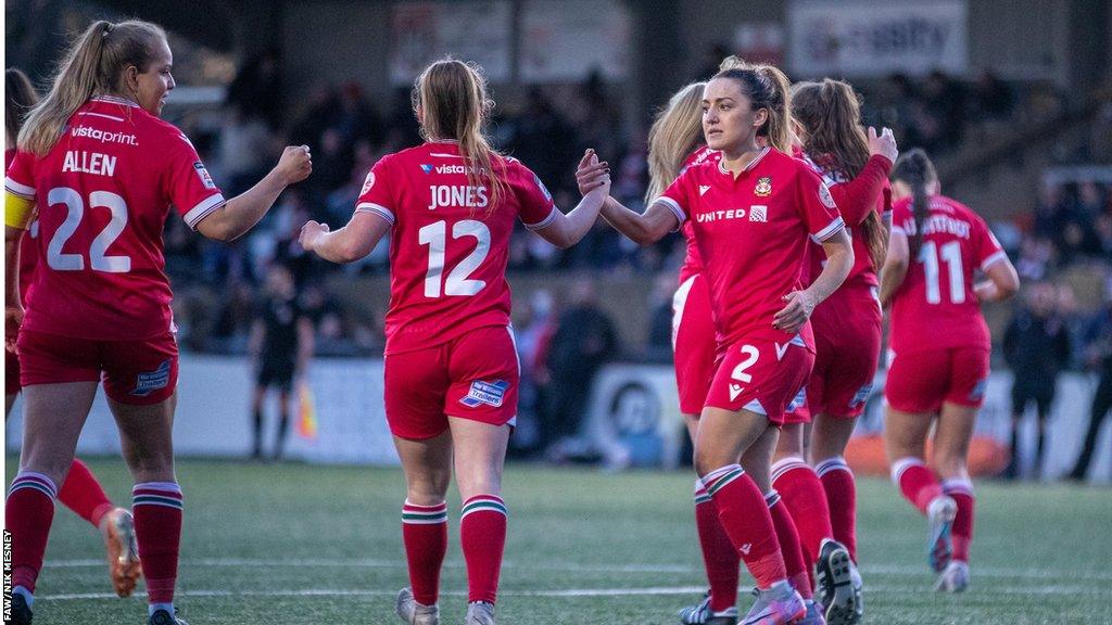 Wrexham women players celebrate a goal