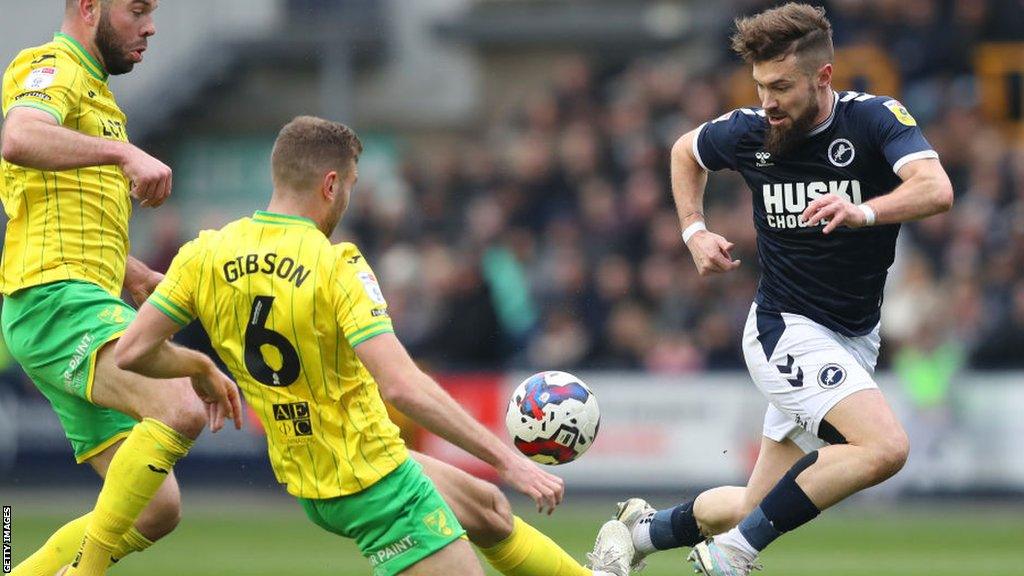 Millwall's Tom Bradshaw (right) challenges for the ball