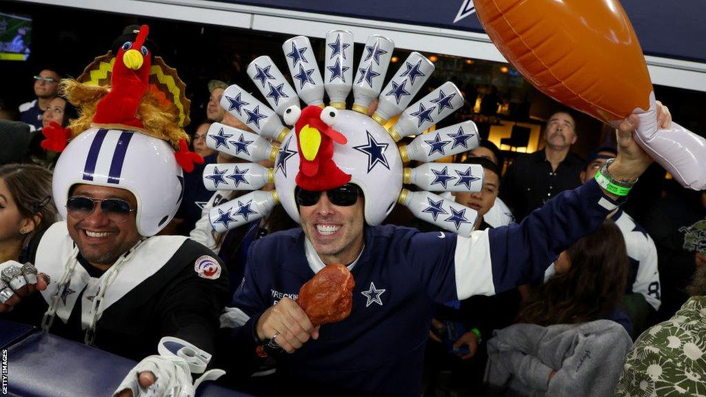 Fans watch the Thanksgiving game between the Dallas Cowboys and the New York Giants