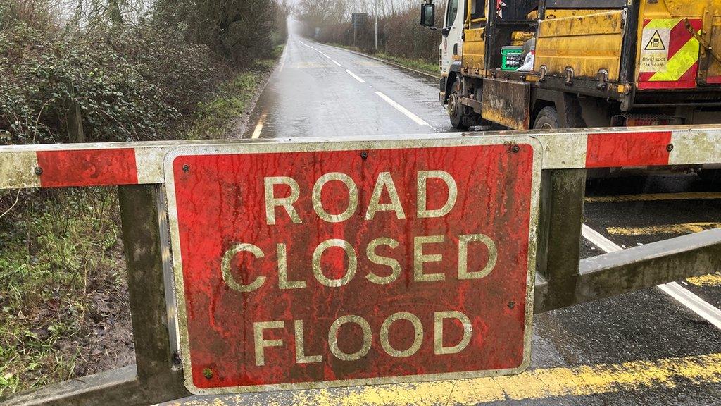 Sign reading "road closed flood"