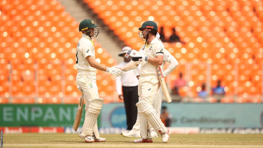 Marnus Labuschagne (L) and Travis Head (R) shake hands while batting together v India