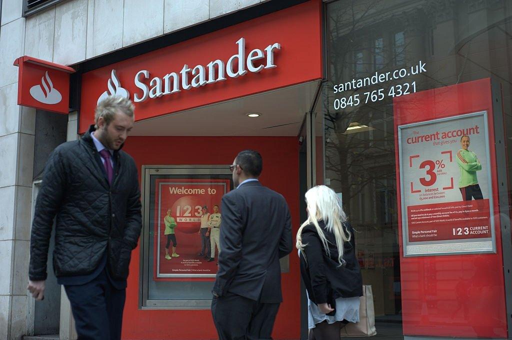 People walk past a Santander branch