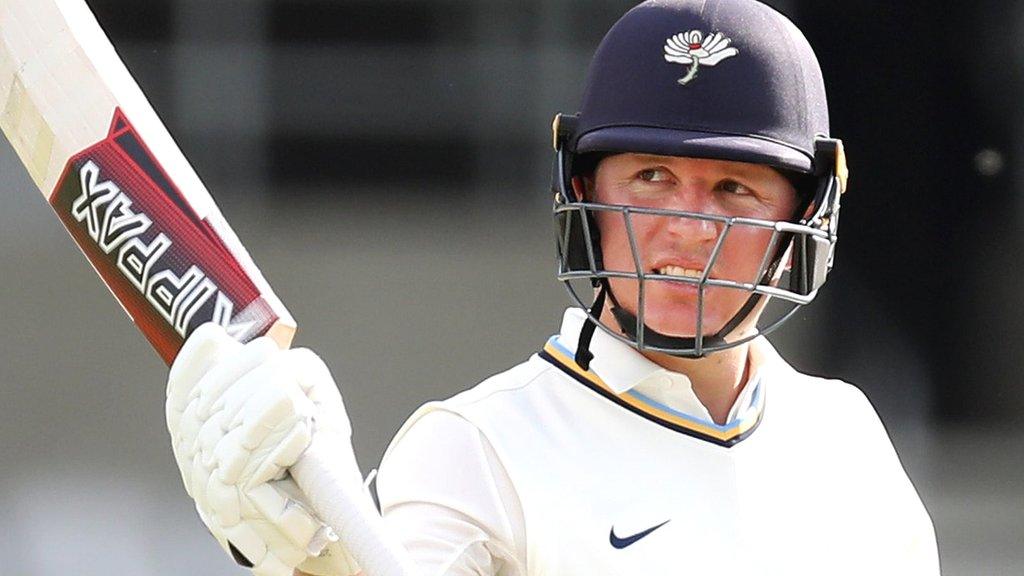 Gary Ballance holds up his bat