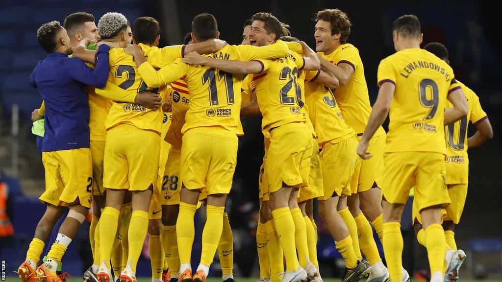 Barcelona's players celebrate on the pitch after being crowned La Liga champions