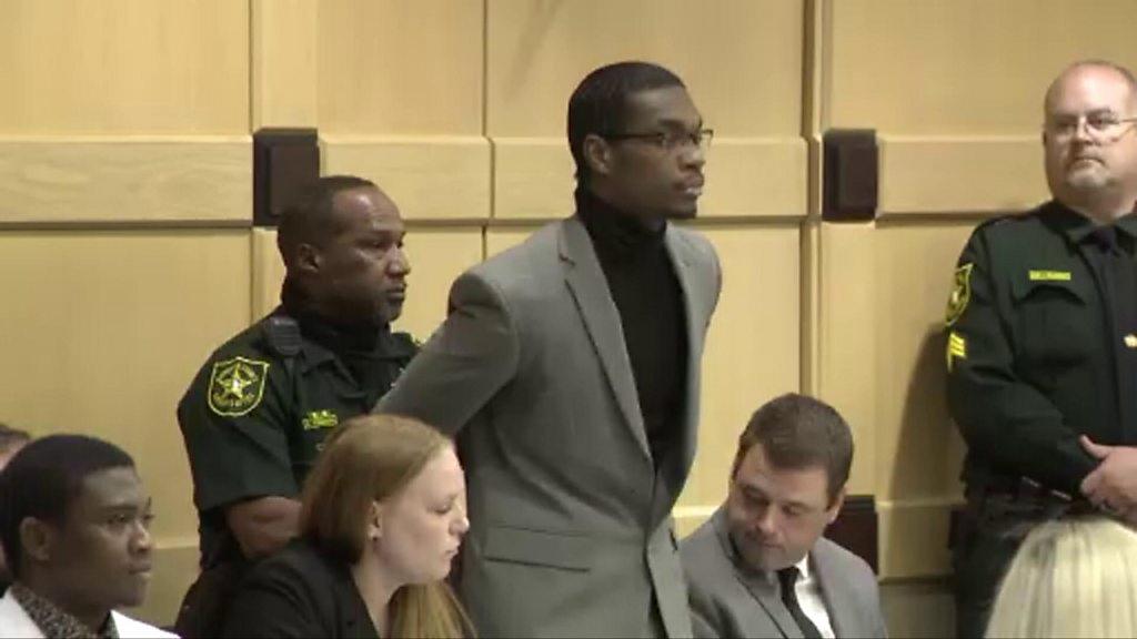 A defendant is handcuffed