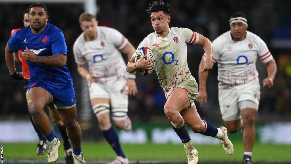 Fly-half Marcus Smith runs with the ball for England against France