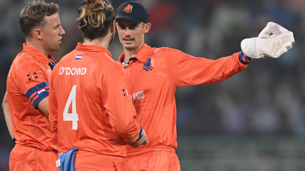 Netherlands players discuss plans in the field