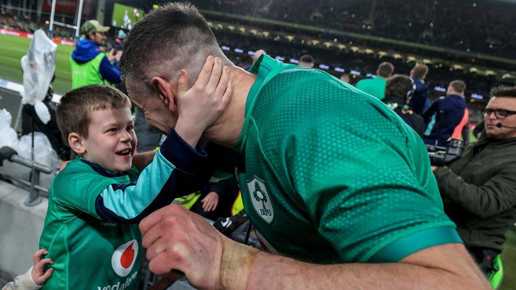 Johnny Sexton embraces his son Luca after beating England