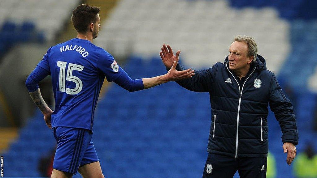 Greg Halford exchanges a high five with Cardiff manager Neil Warnock