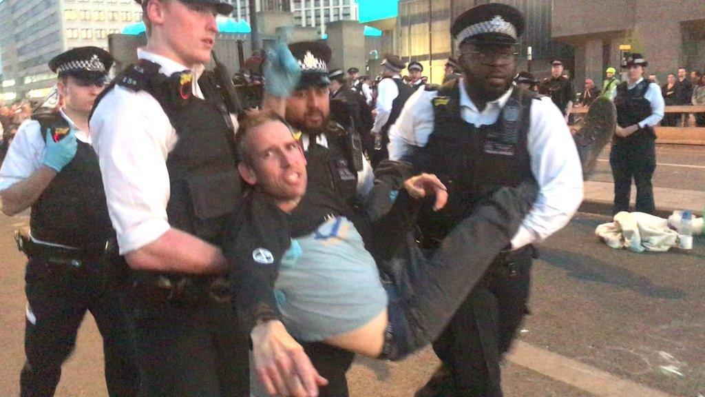 Etienne Stott is carried by police after being arrested