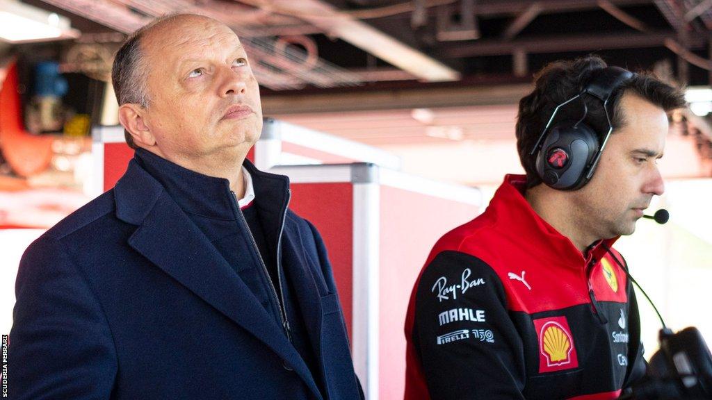 Team principal Frederic Vasseur (left) and a Ferrari colleague watch on from the pit lane