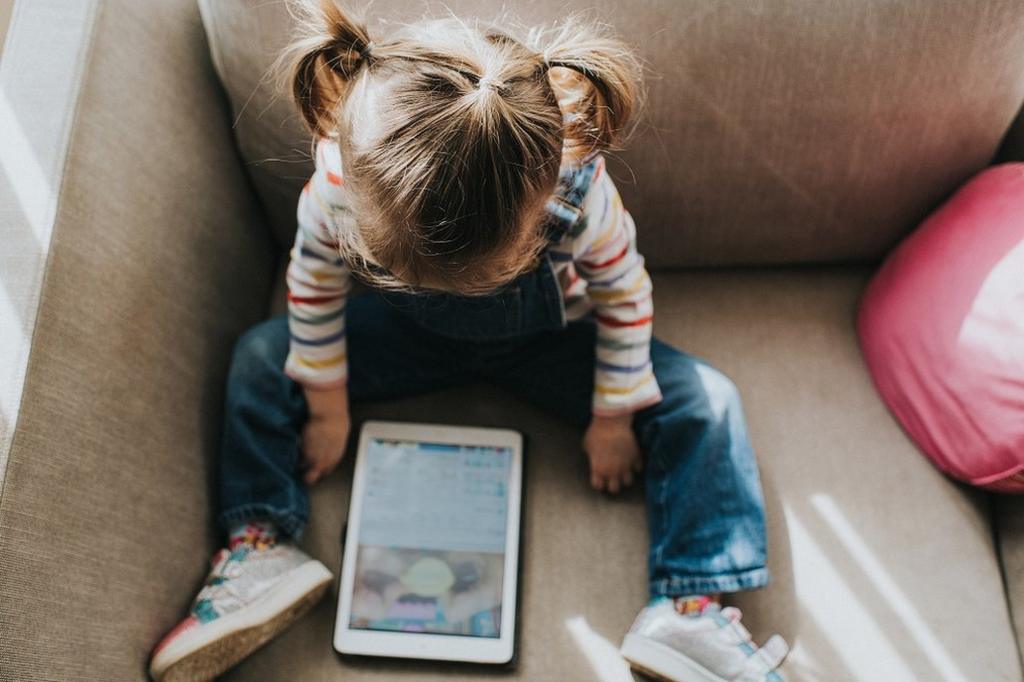 Girl watching TV on iPad