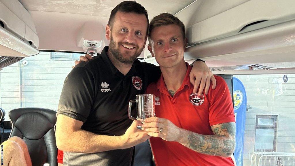 Shane White (right) is honoured by Truro City after making his 250th appearance for the club