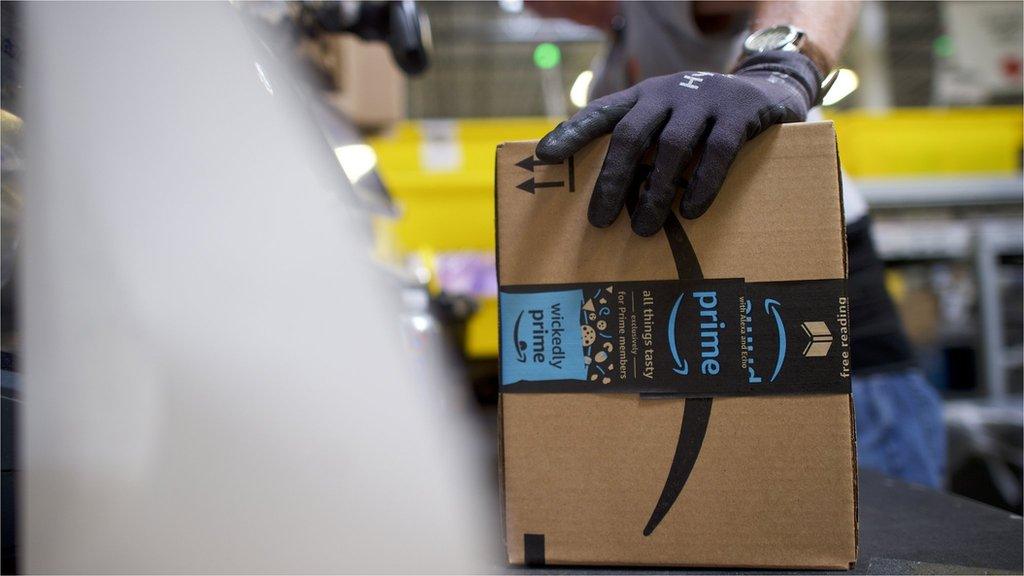 A worker boxes orders at the Amazon Fulfillment Center on August 1, 2017 in Robbinsville, New Jersey.