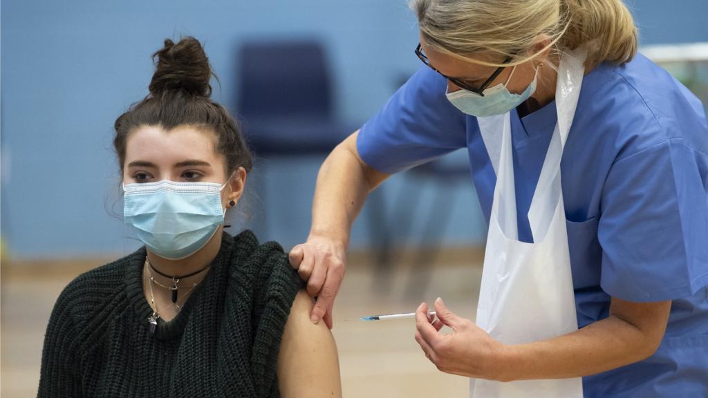 A woman is given a Covid vaccination by a nurse in Cwmbran