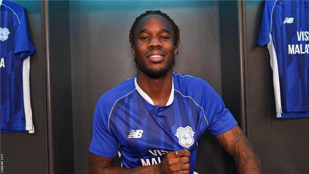 Ike Ugbo shows off the Cardiff City badge