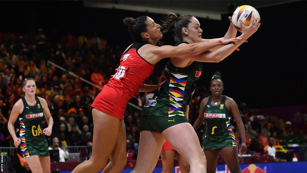 Ella Powell-Davies of Wales and Ine-Mari Venter of South Africa challenge for possession