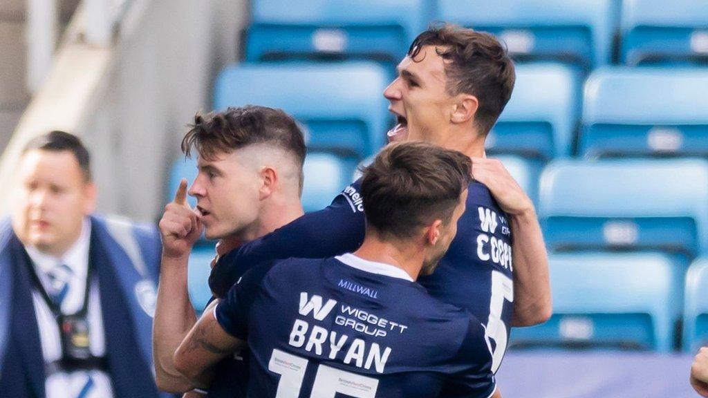 Kevin Nisbet celebrates his goal for Millwall with two of his team-mates