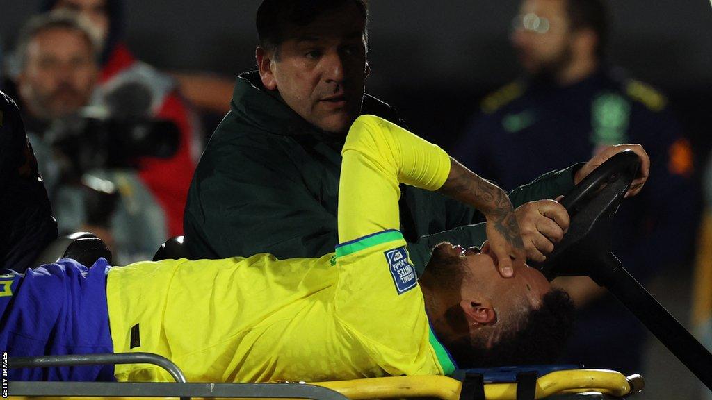 Brazil's forward Neymar leaves the field after an injury