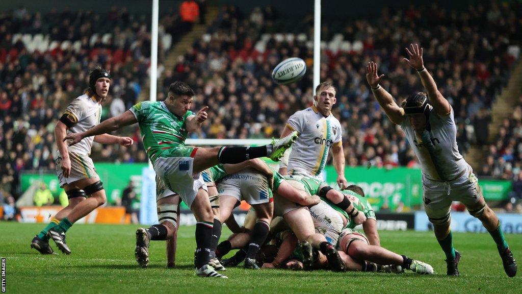 Ben Youngs kicking as a player attempts a charge down