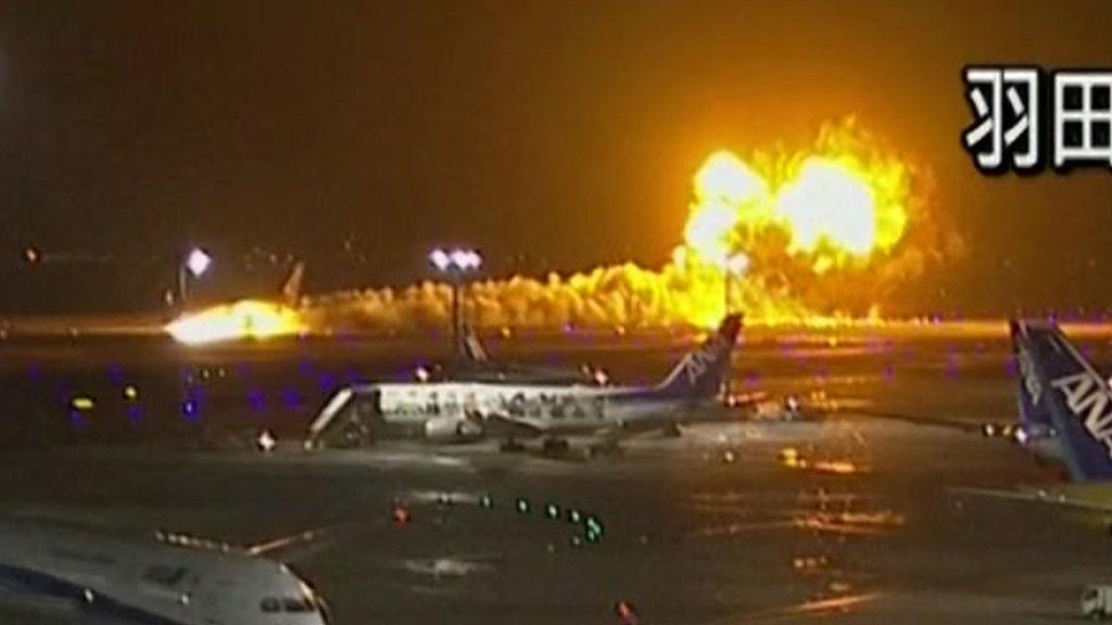 Trail of smoke and flames as plane lands on runway