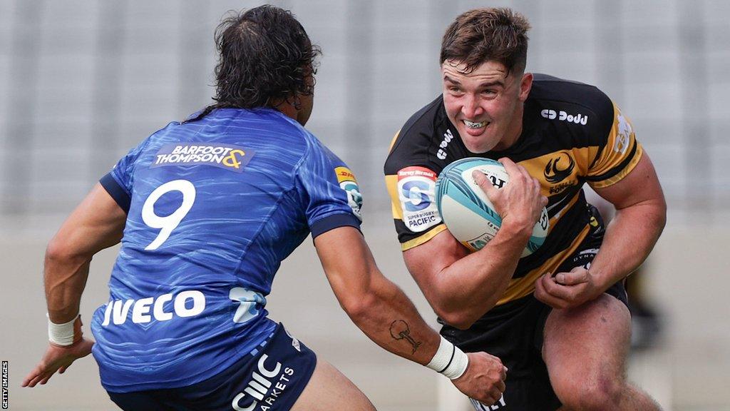 Sam Spink, of Western Force, is challenged by Sam Nock, of Blues