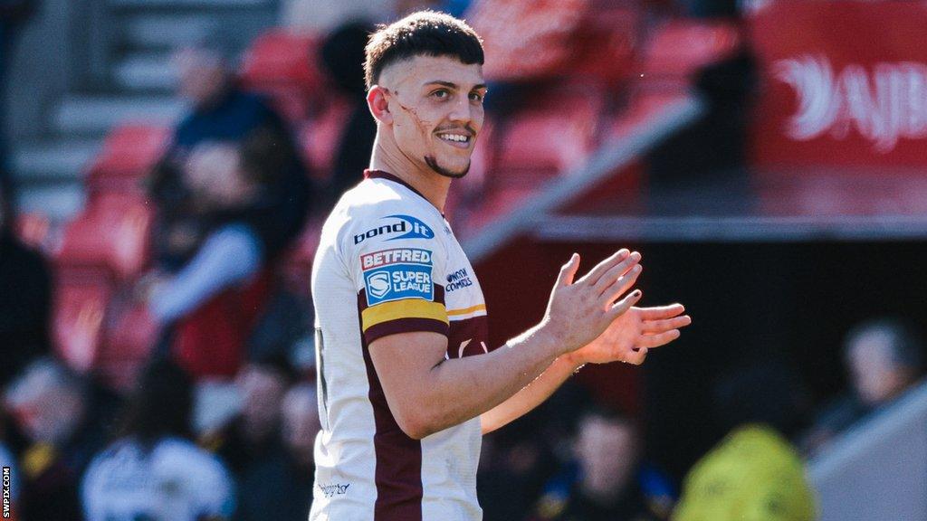 Owen Trout claps during a game for Huddersfield Giants