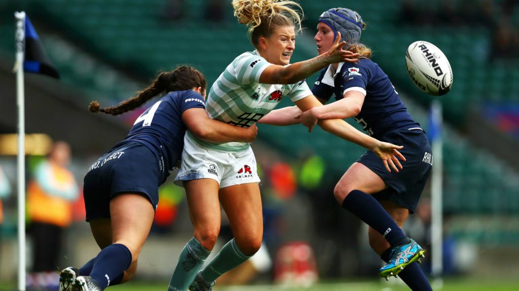 Amelia Miller of Cambridge is tackled