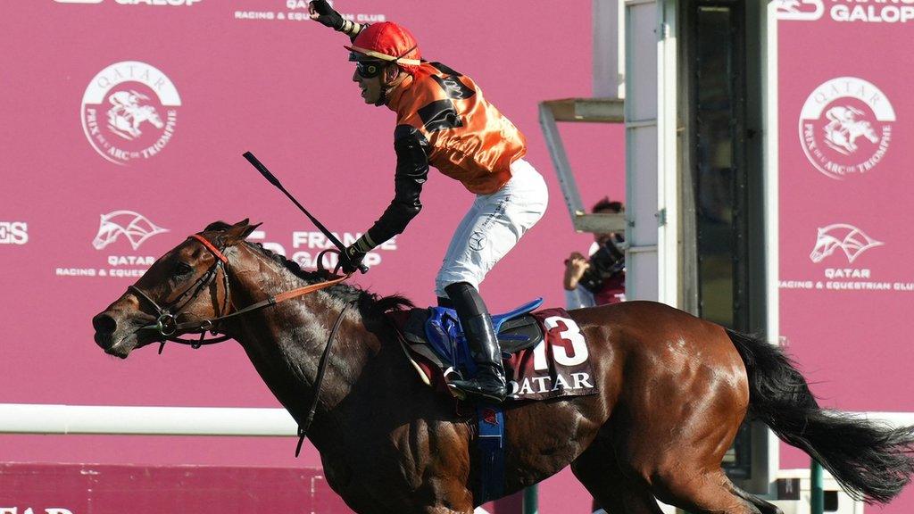 Cristian Demuro celebrates winning the Qatar Prix de l'Arc de Triomphe aboard Ace Impact